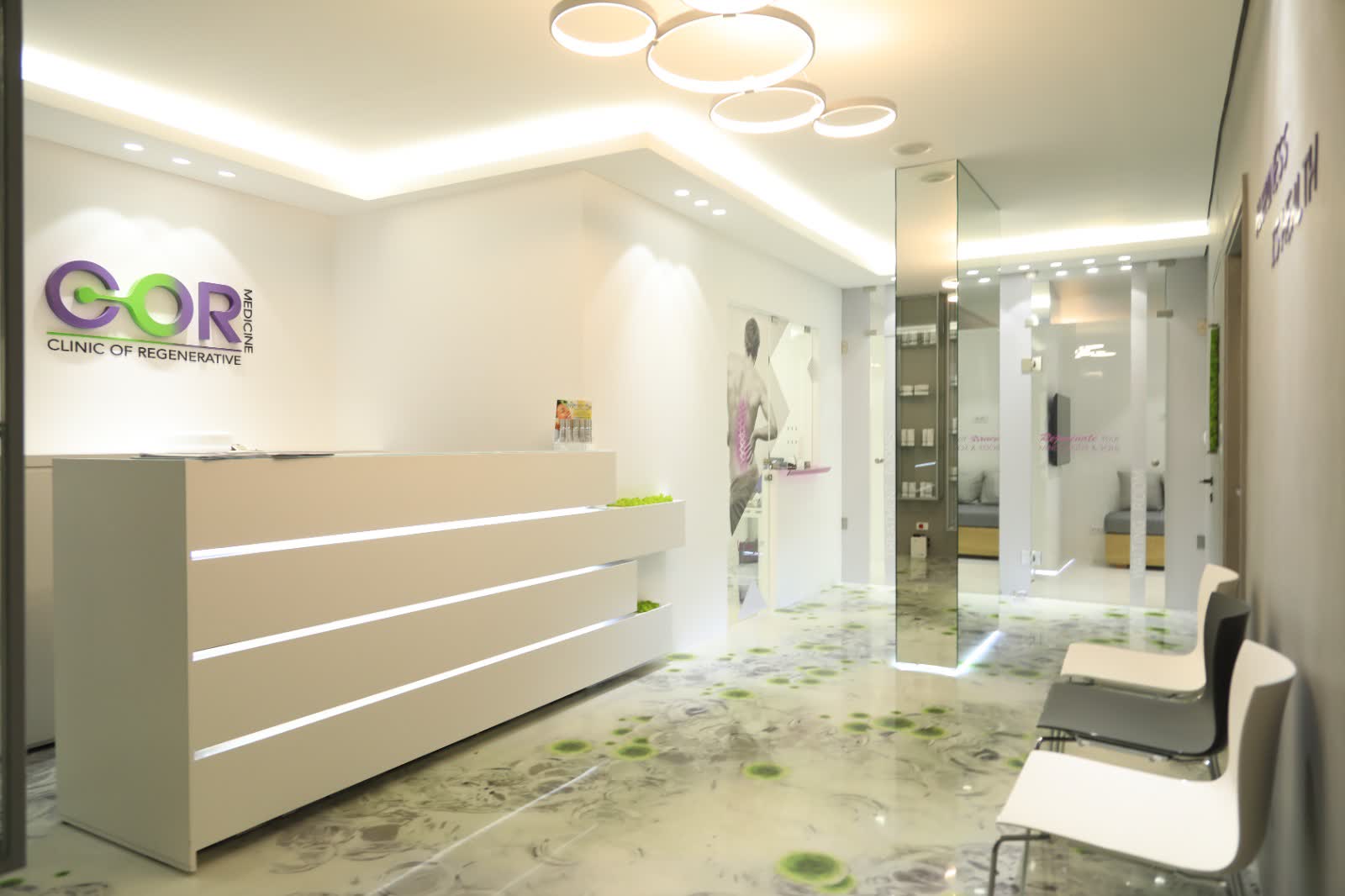 The reception desk at Cormedicine, with the clinic logo on the wall